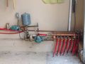 This photo shows the 8 separate loops that flow directly to the heat exchanger. Then it goes to the ½ HP pump to go back to the driveway. It also shows the pipes coming from the water heater that flows to the heat exchanger and back through the ½ HP pump..