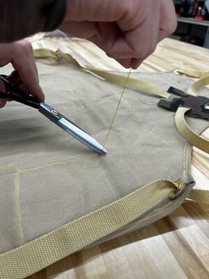 NR Makerspace apron trimming excess thread.jpg