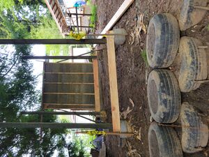 Hempcrete wall with foundational posts and tire retaining wall