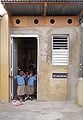 Schoolchildren waving from the front door.
