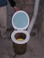 Detail of urine diversion funnel. The funnel is plumbed to a 1” pipe which exits the toilet chute via a 90 degree fitting, and later is plumbed to a gray water system.