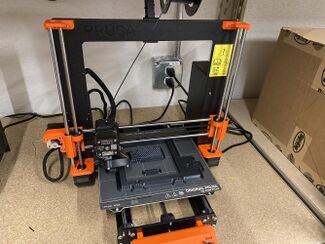 Hobbyist 3D printer making charger holder
