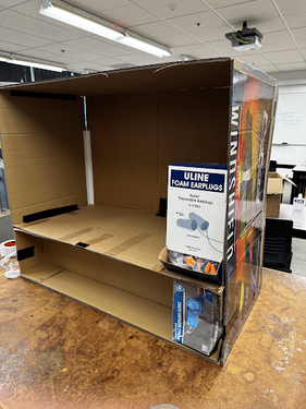 Prototype 1 - Cardboard cabinet with glove box section and ear plugs.