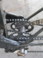 The transmission which connects the pedal powered chain drive from the bike front end to the differential on the rear axle of the trike frame. It sits where the rear wheel hub of the Motobecane 10 speed would be. The bike can be disconnected from the trike frame and a rear wheel can be substituted for the transmission hub.