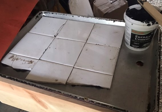 File:Glueing tiles into place.jpeg