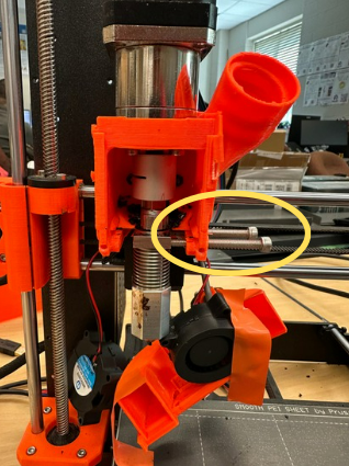 Remove the screws securing the heat block so it is no longer supported. Remove the motor coupler from the top of the auger.
