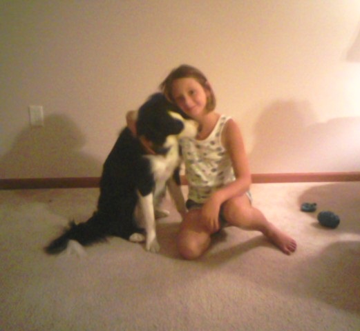 A picture of my sister Alyssa hugging Spencer, my dog.