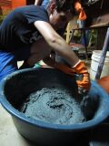 Fig 1i: Mixing sand into plaster ingredients. Hard work! Consistency is almost there.