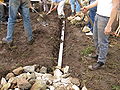 Here students begin to recover the drainage system with dirt