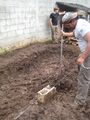 Spacing for posts is measure and holes about one meter deep are dug.