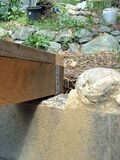 Quick tie also secures the low end of the support beam to the cement retaining wall