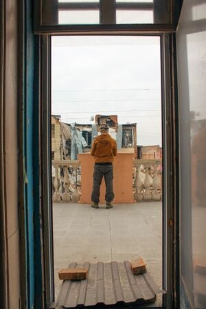 Tolocar operator Ivan Nesterenko assessing a building.