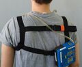 Harness from back with a pump attached.