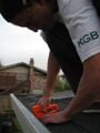 : Figure 12: Attaching the debris filter to the downspout hole.
