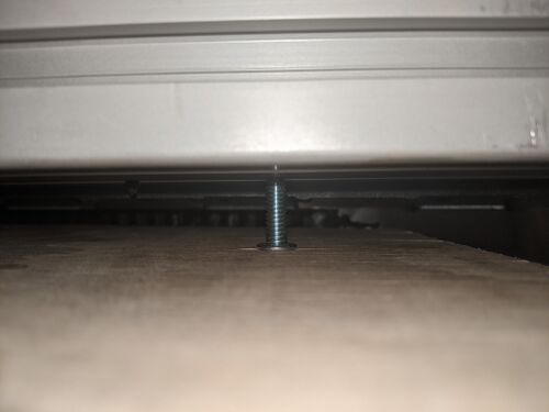 A bolt holding the funnel in place. Four of these are present. This is a photograph looking upwards.