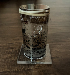 Second prototype of ferrofluid, testing how it behaves in an acrylic container with a saline suspension fluid.