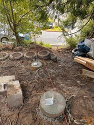 Concrete footings with line levels over them marking where the floor beams would go