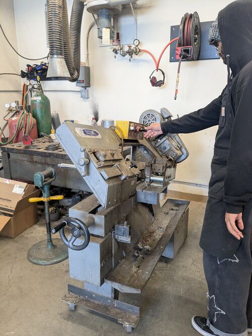 File:MattKerwin FiberworksStation CuttingLegs.jpg
