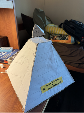 1x1x1 foot Cardboard Trophy Prototype. "Community Side" and title card shown.