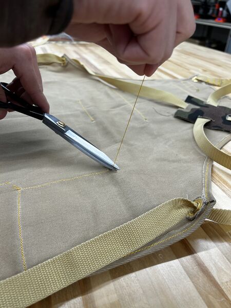 File:NR Makerspace apron trimming excess thread.jpg