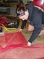 Fig 3g: Mary Wooldridge cutting nylon mesh for drying racks.