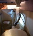 Fig 11: Here you can see the larger vinyl tube attached to the bottom of the funnel. It runs directly into the overflow tube in the toilet.
