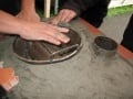 The secondary burner mold was then re-positioned near the chimney inlets (as in step 10) and pressed into the clay to create a seat in the clay for the secondary burner to sit. This process was repeated on the adjacent side