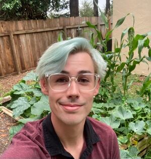 This is a picture of me in front of the raised bed garden I built and grew this summer.