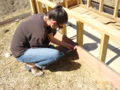 Fig. 9: This is another image of us putting the siding on the beds using a drill.