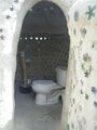 The toilet is flushed with water from the shower greywater basin. The flushed water enters a blackwater tank and overflows into a different garden basin where it provides nutrients and water to plants. If that basin fills there is a third garden bed that serves as an overflow basin for the blackwater.