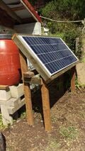 Here is the picture of the solar panel with the lower holding tanks in the background behind it. This is the complete system at the bottom of the hill.