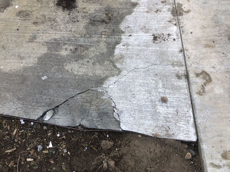 File:Corner of Pathway Crushed by Forklift.jpg