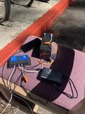 A picture showing the electrical components of our prototype, with a charging phone.