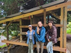 Final photo of Suzuki, Kristina, and Maddy togther next to the completed shed.