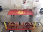 Recyclable cleaning station A cart used to clean cafeteria recyclables.