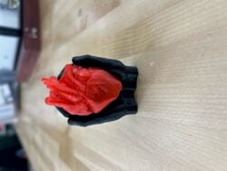 A miniature model of the heart and the hands, printed separately. The purpose of this prototype was to troubleshoot how the hands and heart would slot together.