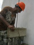 Maestro Gregorio demonstrates proper block laying procedure