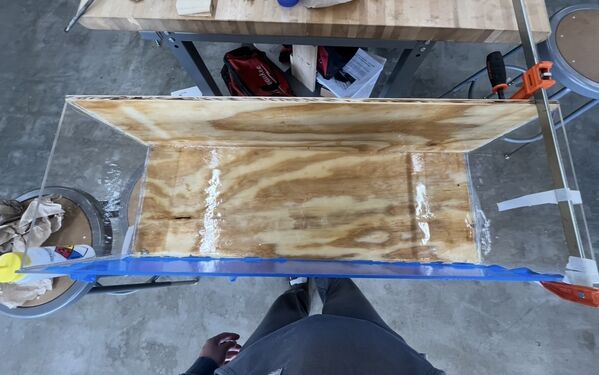 Tsunami tank front piece getting glued with resin top down perspective.
