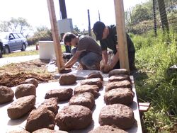 Forming the first batch of bricks into the wall.