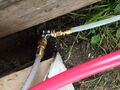 Obtain an additional split valve. Attach the hose to the split valve. Attach two pieces of PEX tubing to both outlets on the split valve using a SharkBite connector. One PEX tube should run be connected to the PEX tubing at the solar collector the other should run to the cold water inlet at the faucet.