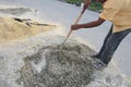 Fig 1d: Gregorio is mixing the fill mixture with a shovel which is extremely tedious and difficult.