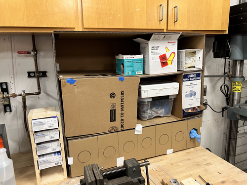 Prototype 1 - Cardboard cabinet filled with PPE after being left in the Makerspace.
