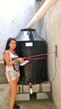 6. Arlene attaching the finishing touches to the system. We attached instructional signs in spanish.