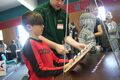 Figure 10: A young boy learning how to operate the Pendulum Wave Machine.