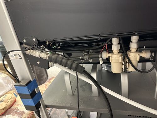 Visible WAZER water lines and machine-side water connections.