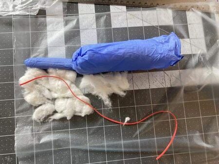 Completed appendicitis model showing the appendix, cecum, mesoappendix, and terminal ileum assembled from a vinyl glove and cotton.
