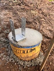 Finished pier with 4"x4" metal anchor (rebar cage cured inside for stability)