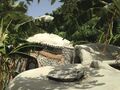 The earthship design incorporates passive rainwater catchment. All of the water that falls on the roof of the main room, the archway, or the restroom is guided to a water storage tank by the contours of the roof. That water can then be collected from a spigot and be used for toilet flushing, showering, or any other necessary task.