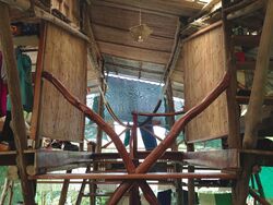 Bamboo walls and roof and timber branch supports.