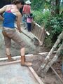 Fig. 9f: Carrie Schaden burying the tank bound pipe to allow a footpath